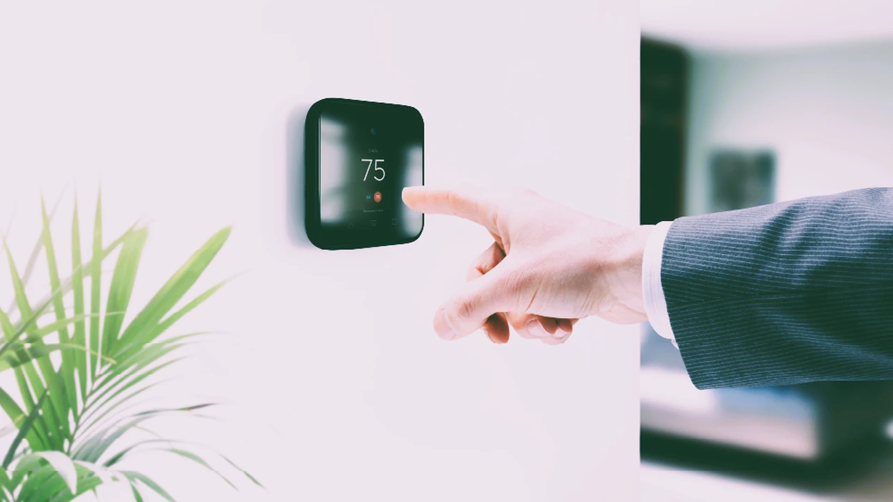 Close up on a plate of mashed potatoes, topped with baked pork chops with cream of mushroom soup, and a side of green beans.