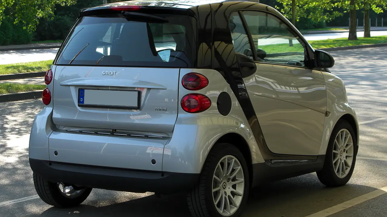 Two mint chocolate milkshakes with whipped cream and green sprinkles.