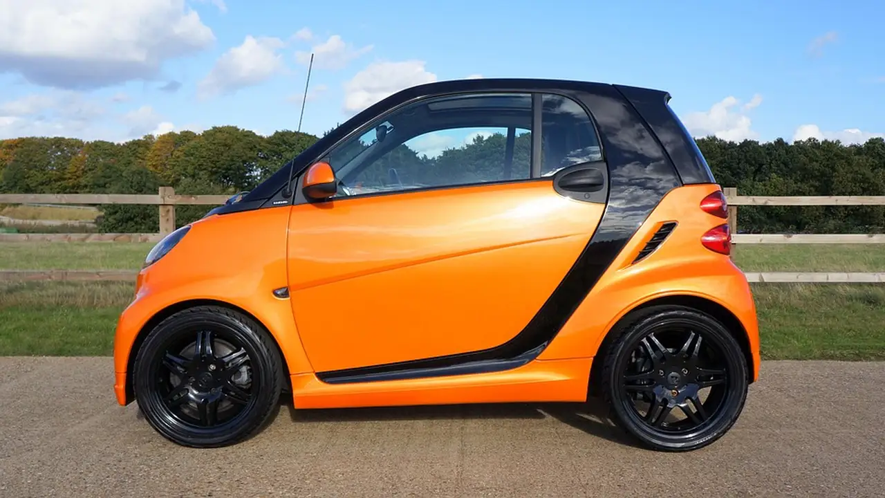 Close up on a plate of mashed potatoes, topped with baked pork chops with cream of mushroom soup, and a side of green beans.